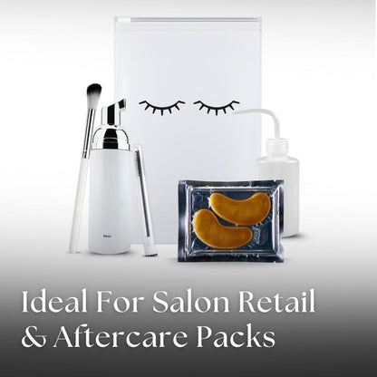 Salon retail and aftercare packs including a white container, brush, and eye mask on a light gray background.